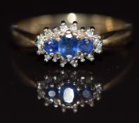 A 9ct gold ring set with sapphires surrounded by diamonds, 2.2g, size M