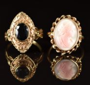 A 9ct gold ring set with a coral cameo and a 9ct gold ring set with an oval cut sapphire, 8.6g, size