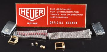 A small collection of watch parts and accessories comprising two Omega stainless steel clasps,