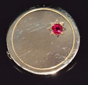 An 18ct gold brooch set with a ruby of approximately 0.3ct in a star setting, 10.1g