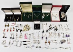 A large collection of silver and crystal earrings