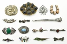 A collection of brooches including Victorian brooch set with scarab beetles, silver brooch set