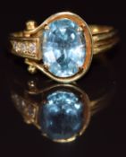 An 18k gold ring set with an oval cut topaz and diamonds, size L/M, 3.6g