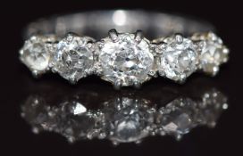 A platinum ring set with five old cut diamonds, the centre diamond approximately 0.45ct, 3.3g,