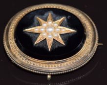 Victorian mourning brooch set with jet and seed pearls in a star setting, verso a locket