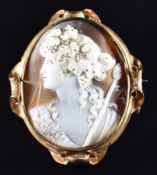 Victorian yellow metal brooch set with a cameo depicting a young woman with vines in her hair