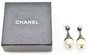 A pair of Chanel earrings set with faux pearls, marked Chanel to back, in Chanel box