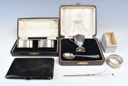 Cased pair of hallmarked silver napkin rings, cased hallmarked silver egg cup and spoon and a