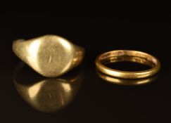 A 22ct gold wedding band/ ring (2.3g) and an 18ct gold signet ring (7g)
