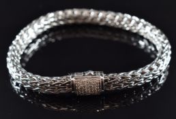 A plaited silver bracelet with diamond encrusted clasp