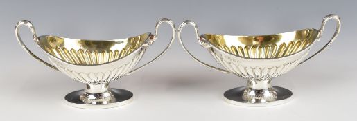 Pair of Victorian hallmarked silver twin handled open salts with gilt wash interiors, London 1886,