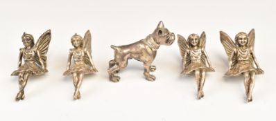 Four novelty white metal seated fairies and a dog, all marked 925, length of dog 4cm, weight of