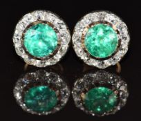 A pair of Victorian earrings each set with round cut emeralds of approximately 1ct surrounded by old