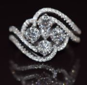 An 18ct white gold ring set with four diamonds of approximately 1.38ct and a further 79 totalling