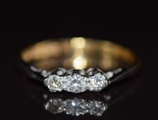 An 18ct gold ring set with three diamonds in a platinum setting, 2g, size J