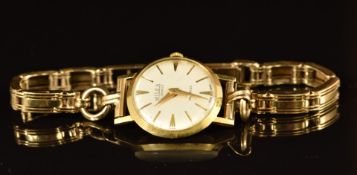 Milex 18ct gold ladies wristwatch with gold hands and hour, silver dial and 21 jewel movement, on