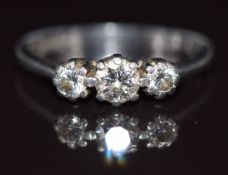 A platinum ring set with three diamonds, the centre diamond approximately 0.3ct, 4.4g, size L