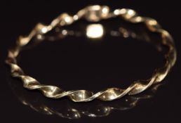 A 9ct gold bangle in a twist design, 5.8g