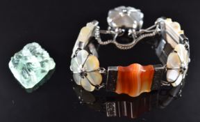 A carved quartz plaque depicting a butterfly and a Victorian silver bracelet set with agate with