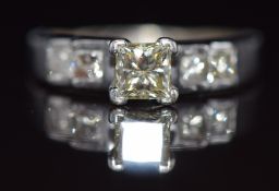 A 14ct gold ring set with a princess cut diamond of approximately 0.6ct and four further princess