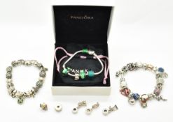 Three silver Pandora bracelets with over forty silver Pandora charms including robin, owl, fish,