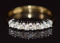 An 18ct gold ring set with seven diamonds, each approximately 0.05ct, 2.8g, size L