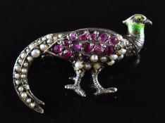 A silver brooch in the form of a pheasant set with rubies, seed pearls and enamel, width 3.2cm