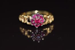An 18ct gold ring set with a cluster of rubies, 2.5g, size K