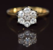 An 18ct gold ring set with seven diamonds in a cluster, each diamond approximately 0.09ct, 3.3g,