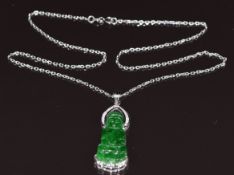 An 18k white gold pendant set with a carved jadeite plaque in the form of Guanyin and diamonds, on