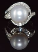 An 18ct white gold ring set with a 15.11ct South Sea pearl surrounded by round and baguette cut