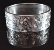 A silver bangle with engraved decoration, Birmingham 1935