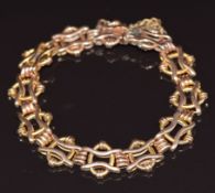 A 9ct rose gold bracelet made up of oval and wavy links, 12g