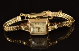 J W Benson 9ct gold ladies wristwatch with gold hands and Arabic numerals, silver dial and quartz