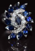 An 18k white gold ring set with marquise cut sapphires and round cut diamonds, size M, 8.4g