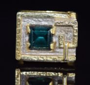 A 1970s 18ct gold ring set with a quartz in a raised rectangular mount, with textured surface to the