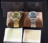 Two Michael Kors wristwatches, one with silver hands and dial and stainless steel case on