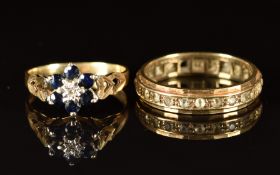 A 9ct gold ring set with a diamond surrounded by sapphires (size L) and a 9ct gold eternity ring set