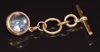 An 18ct gold charm set with a compass on 18ct gold T bar, maker M & M, 24.3g