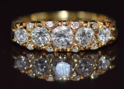 An 18ct gold ring set with thirteen diamonds, the centre diamond approximately 0.4ct, 5.6g, size P