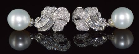 A pair of 18ct white gold earrings set with round and baguette cut diamonds totalling 1.83ct and