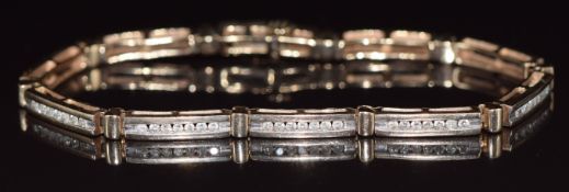 A 9ct gold tennis bracelet set with baguette and round cut diamonds, 14.1g