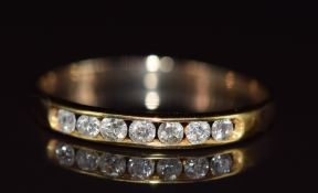 A 9ct gold ring set with seven diamonds, total diamond weight 0.25ct, 0.9g, size O