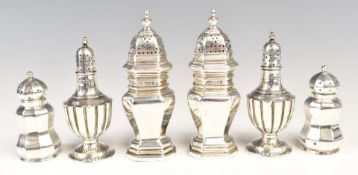 Three pairs of hallmarked silver peppers, one pair London 1924, maker Goldsmiths & Silversmiths Co