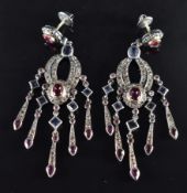 A pair of silver earrings set with tourmaline, tanzanites and diamonds