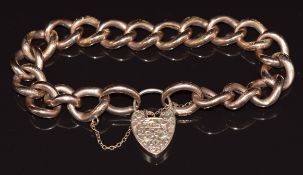 A 9ct rose gold curb link bracelet with engraved links and heart padlock clasp, 25.2g
