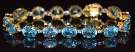 An 18k gold bracelet set with oval cut topaz and cubic zirconia, 22.5g