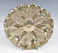 Victorian hallmarked silver pierced and embossed bon bon dish raised on three ball feet,