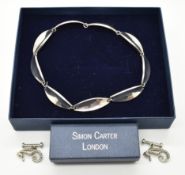 Danish silver necklace by Just Anderson and a pair of Simon Carter cufflinks in the form of