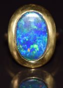 A 22ct gold ring set with a black opal doublet, 11.2g, size J